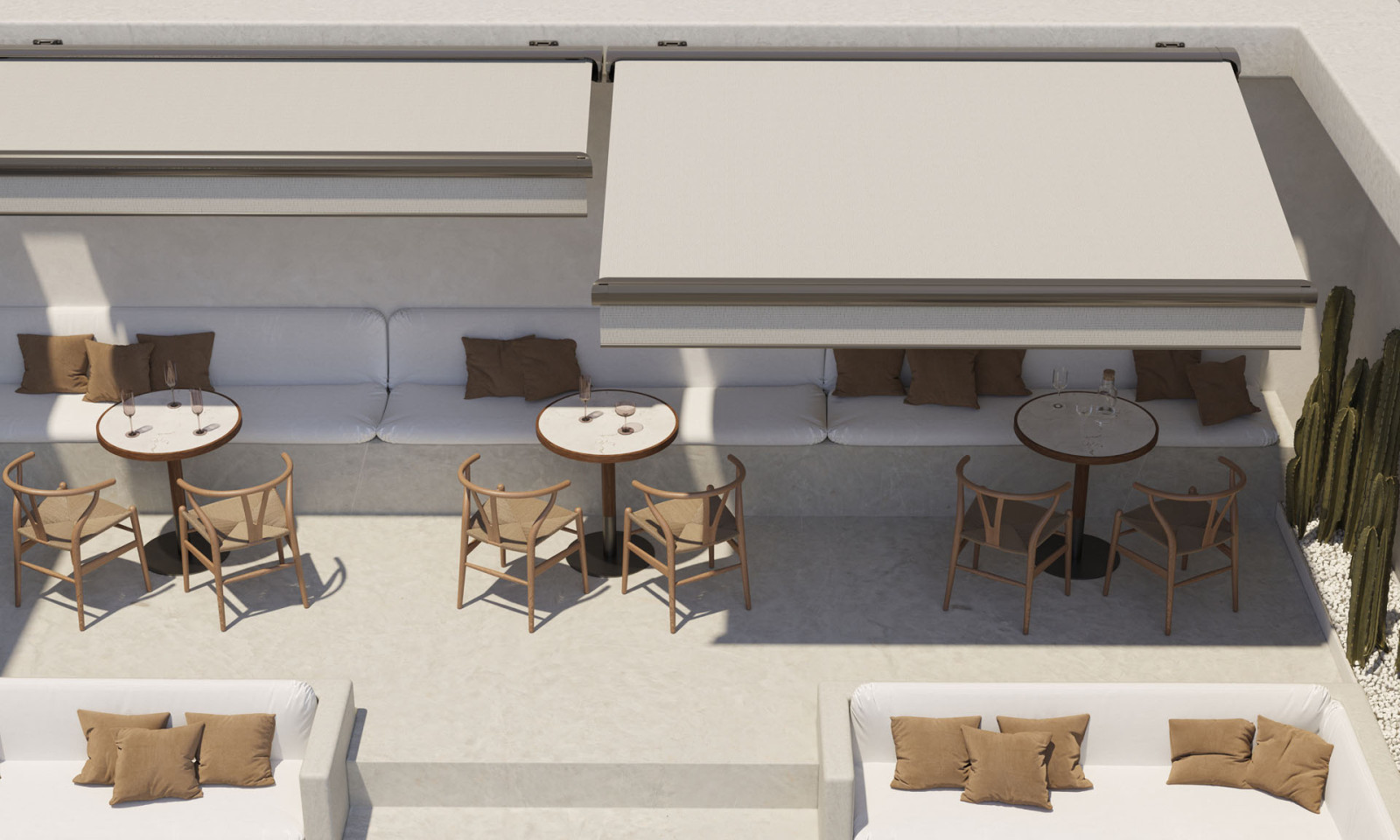 Outdoor seating area with white couches and tables, featuring a Fully Automatic Awning System