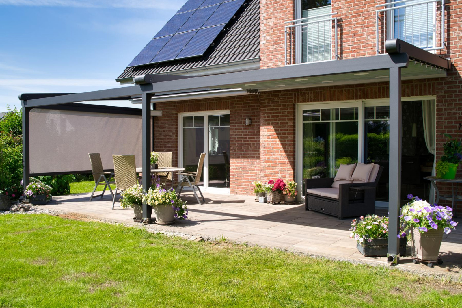 A covered patio with a solar panel, showcasing powerful side enclosures designed by Palmiye Global for full protection.