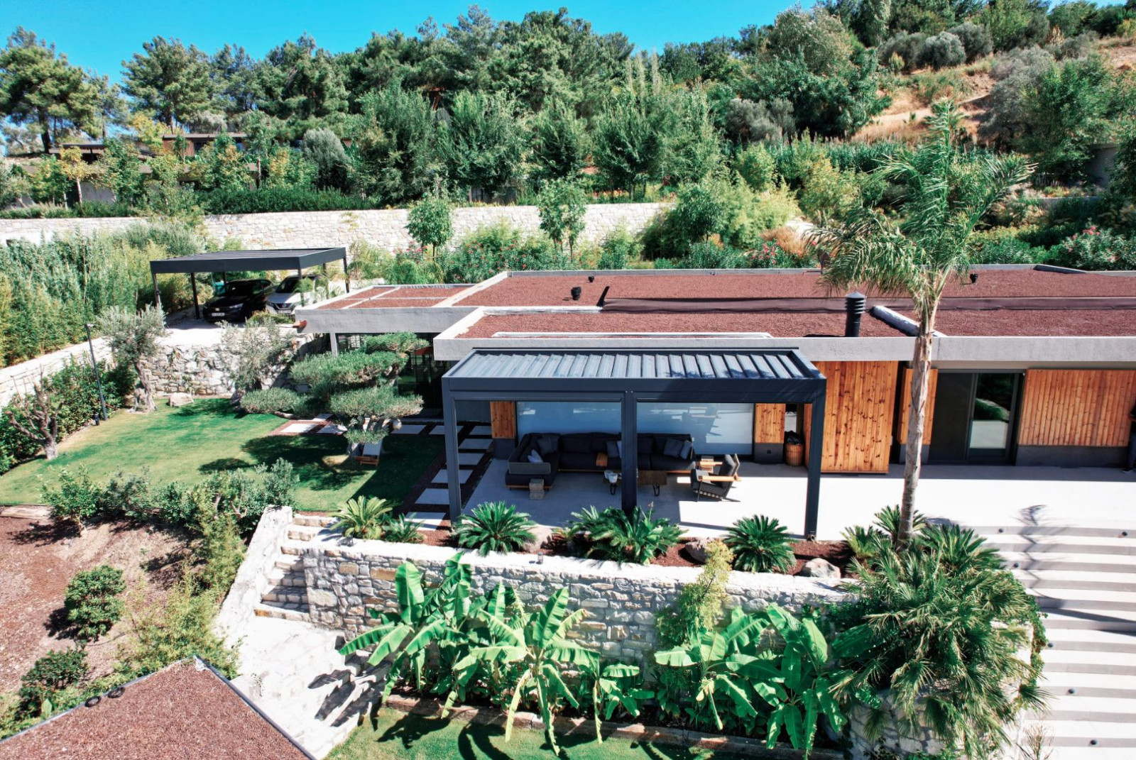 1. A modern house with a large garden, swimming pool, and a stylish pergola designed for summer spaces by Palmiye Global.